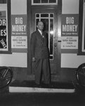 Man in a suit standing in front of William's Store. Broadway, Va. by William Garber