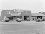 Heishman's Garage. Banner hangs on front of building advertising the "new 1950 Studebaker." by William Garber