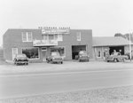 Heishman's Garage. Banner hangs on front of building advertising the "new 1950 Studebaker." by William Garber