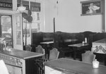 Inside of Quedens Lunch Billiards, New Market, Va. View from behind the counter in the front of the restaurant, with wooden booths and a pinball machine pictured. by William Garber