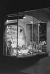 The front window of Hodgin's Store (electronics and sporting goods) in Woodstock, Va. Window advertises National Baseball Week, April 3-10. by William Garber