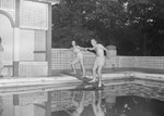 Two people standing on the diving board of the swimming pool at the Shenandoah Alum Springs Hotel. Orkney Springs, Va. by William Garber