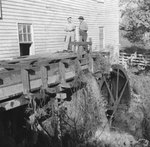 Bryce's Mountain Resort, close-up of two men standing on the water wheel. Basye, Va. by William Garber