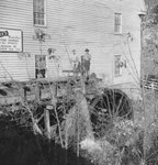 Bryce's Mountain Resort, side view of two men standing on the water wheel. Basye, Va. by William Garber