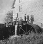 Bryce's Mountain Resort, side view of two men standing on the water wheel. Basye, Va. by William Garber