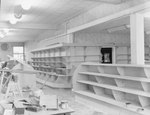 Empty shelving inside of a store or building, alternate view. by William Garber