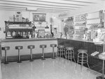 Inside of a store, with a view of the refreshment counter. by William Garber