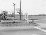 View of the intersection at Kamp Washington, Fairfax, Va, with two police officers on the far left and a residential dwelling in the background by William Garber