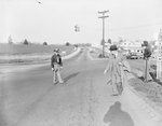 Two police officers and a pedestrian at the intersection at Kamp Washington, Fairfax, Va. by William Garber