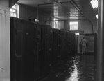 One man standing in a large storage or freezer room by William Garber