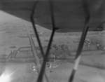 View of various farms that is obstructed by a part of the plane by William Garber