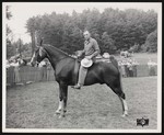 Broadway Horse Show, a man posing on a horse with a trophy in his hand by William Garber
