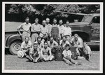 Employees of the Shenandoah Valley Electric Cooperative posing next to a truck and a few pieces of equipment by William Garber
