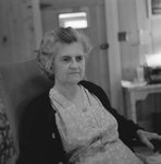 Elderly woman sitting inside of Mt. Jackson Mill. by William Garber