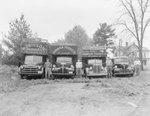 Robinson Produce Trucks, each of a different size and with their respective drivers standing to the side by William Garber