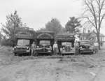 Robinson Produce Trucks, each of a different size and with their respective drivers standing to the side by William Garber