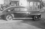 Private automobile, parked on a street or roundabout. Side view by William Garber