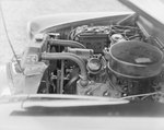 View of the engine underneath a hood of a car by William Garber
