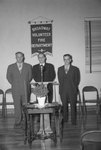 Broadway Volunteer Fire Department, possibly an open house; three men in suits standing behind a podium by William Garber