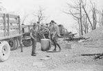 A group of CCC workers gathered around a trash canister by William Garber