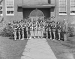 Timberville (High) School, women's basketball team, lined up in front of the school with their coach by William Garber