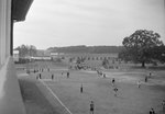 View of a large number of people on a sports field, taken from an upper story window and from a distance by William Garber