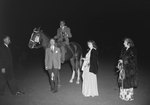 Timberville Horse Show, a man riding a horse with a trophy and a ribbon, while three women stand nearby and a man walks into the shot by William Garber