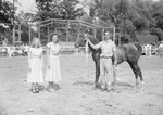 Timberville Horse Show, two girls standing next to a man who is holding the reins of a horse by William Garber