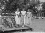 Timberville Horse Show, three women standing on a platform, one holding a trophy and one holding a bridle by William Garber