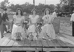 Timberville Horse Show, three women sitting in chairs on a platform holding horse bridles, ribbons, and a trophy by William Garber
