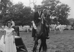 Broadway Horse Show, a man in a suit riding a horse and holding a ribbon by William Garber