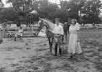 Broadway Horse Show, a young man and woman standing next to a horse by William Garber