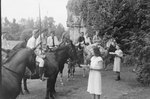 A number of horse riders lined up in front of two women. One rider holds a lance. Natural Chimneys, Mount Solon, Va. by William Garber