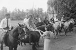A line of horse riders, some holding lances, with one accepting a drink from a woman on the ground. Natural Chimneys, Mount Solon, Va. by William Garber