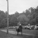Man jousting, with spectators in the background. Natural Chimneys, Mount Solon, Va. by William Garber