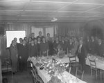 A large group of men wearing suits posing at a banquet of sorts hosted by the Gulf company by William Gaber
