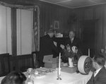 Two men in suits shaking hands at the head of the banquet table, hosted by Gulf by William Gaber