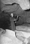 A woman playing a violin inside of a large cavern by William Gaber