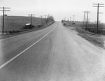 Distant view of a tractor-trailer laying on its side, not far from the road, pictured on the far left by William Garber