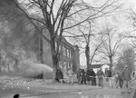 A group of men working to extinguish a large building fire by William Garber