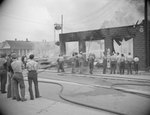 A group of men trying to extinguish a large building fire by William Garber