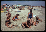 Kathy, kids and their beach friends digging a ditch in sand by James Madison University